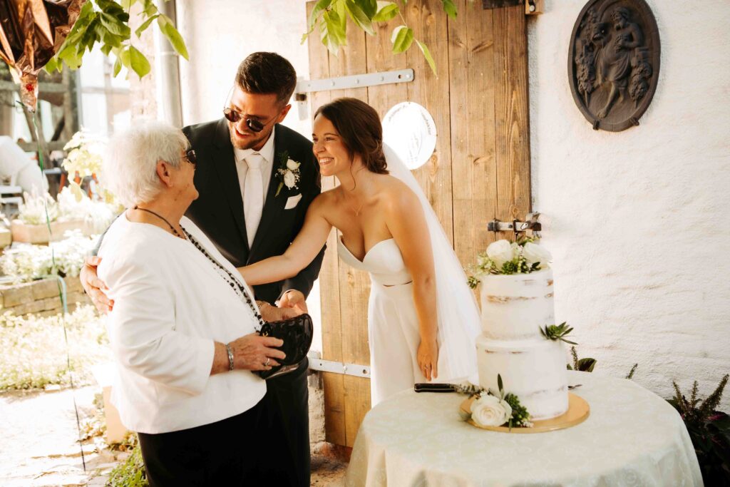 Herzlicher Moment: Oma gemeinsam mit Brautpaar und Torte